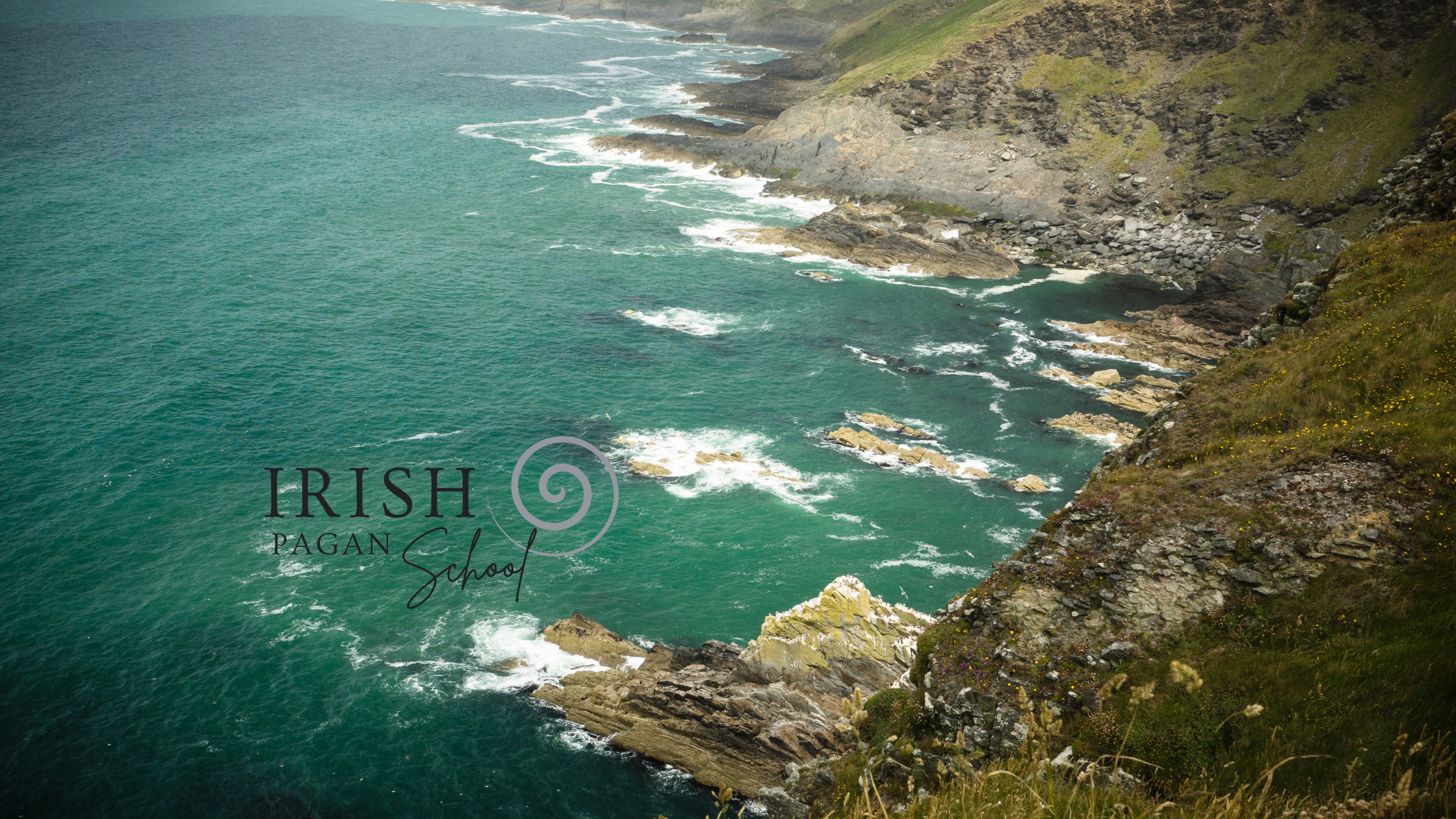 The image depicts a dramatic coastal landscape in Ireland, with cliffs covered in grass and wildflowers descending into the rocky shoreline below. Waves crash gently against the rugged rocks, with the sea displaying rich shades of turquoise and deep green. The scene evokes the mystical, natural beauty often associated with Irish myth and folklore. The logo of the "Irish Pagan School" is overlaid on the image, featuring a spiral design representing connection to Irish spirituality.